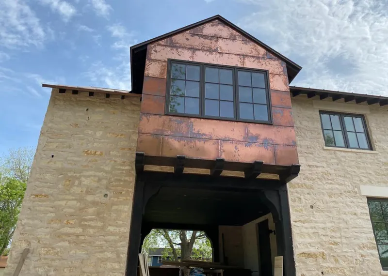 Copper metal panel facade on a stone building for Skylight Installation in DuBois